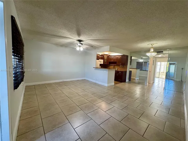 a kitchen with refrigerator cabinets and stove top oven
