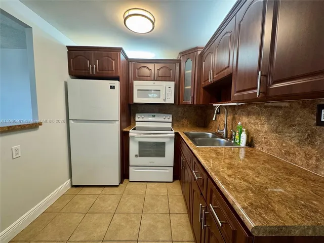 a kitchen with a refrigerator sink and stove
