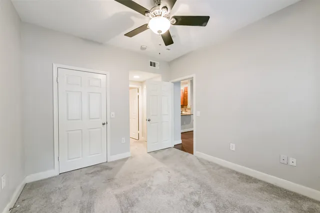 a view of walk in closet with empty racks