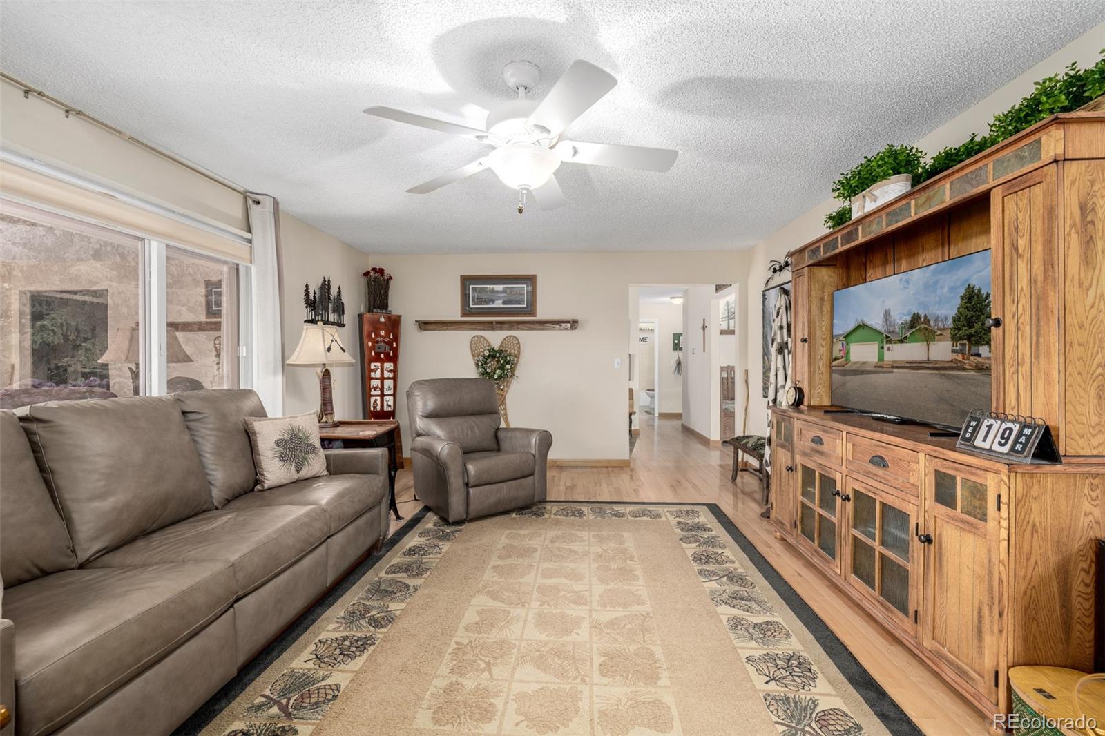 22 Scott Drive North Broomfield, CO 80020 - Photo 11 of 49 a living room with furniture and a flat screen tv