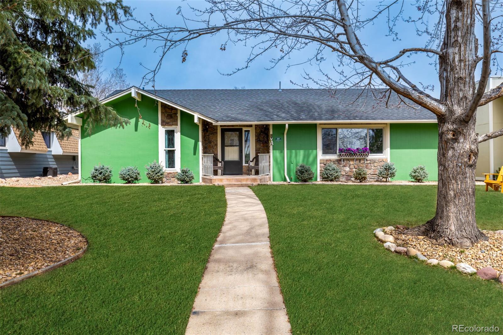 22 Scott Drive North Broomfield, CO 80020 - Photo 2 of 49 a front view of a house with a yard table and chairs
