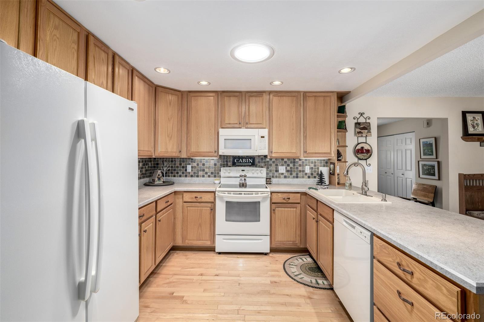 22 Scott Drive North Broomfield, CO 80020 - Photo 21 of 49 a kitchen with a refrigerator a sink and cabinets