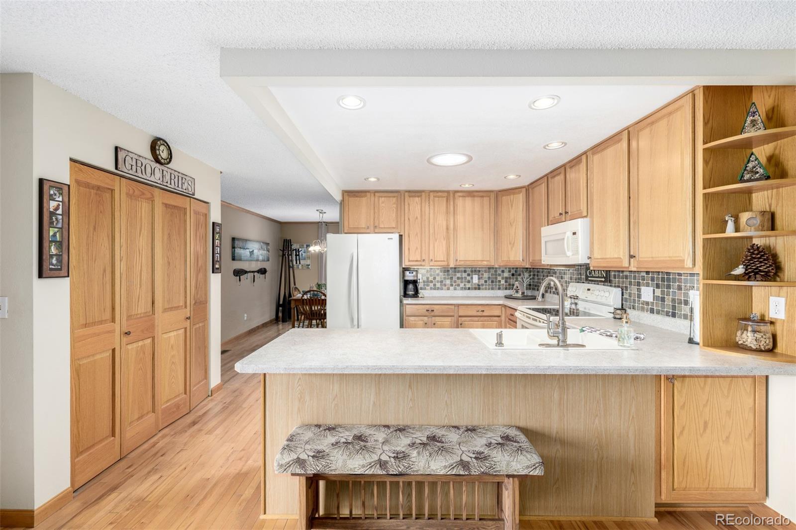 22 Scott Drive North Broomfield, CO 80020 - Photo 23 of 49 a kitchen with stainless steel appliances granite countertop a refrigerator and a stove top oven