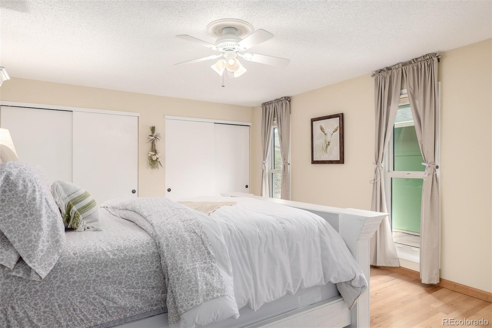 22 Scott Drive North Broomfield, CO 80020 - Photo 26 of 49 a bedroom with a large bed and a chandelier