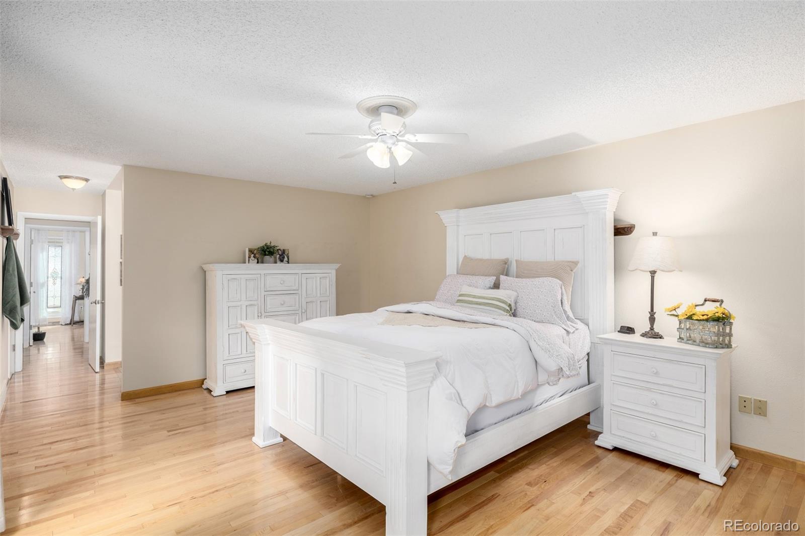 22 Scott Drive North Broomfield, CO 80020 - Photo 27 of 49 a bedroom with a bed and a chandelier