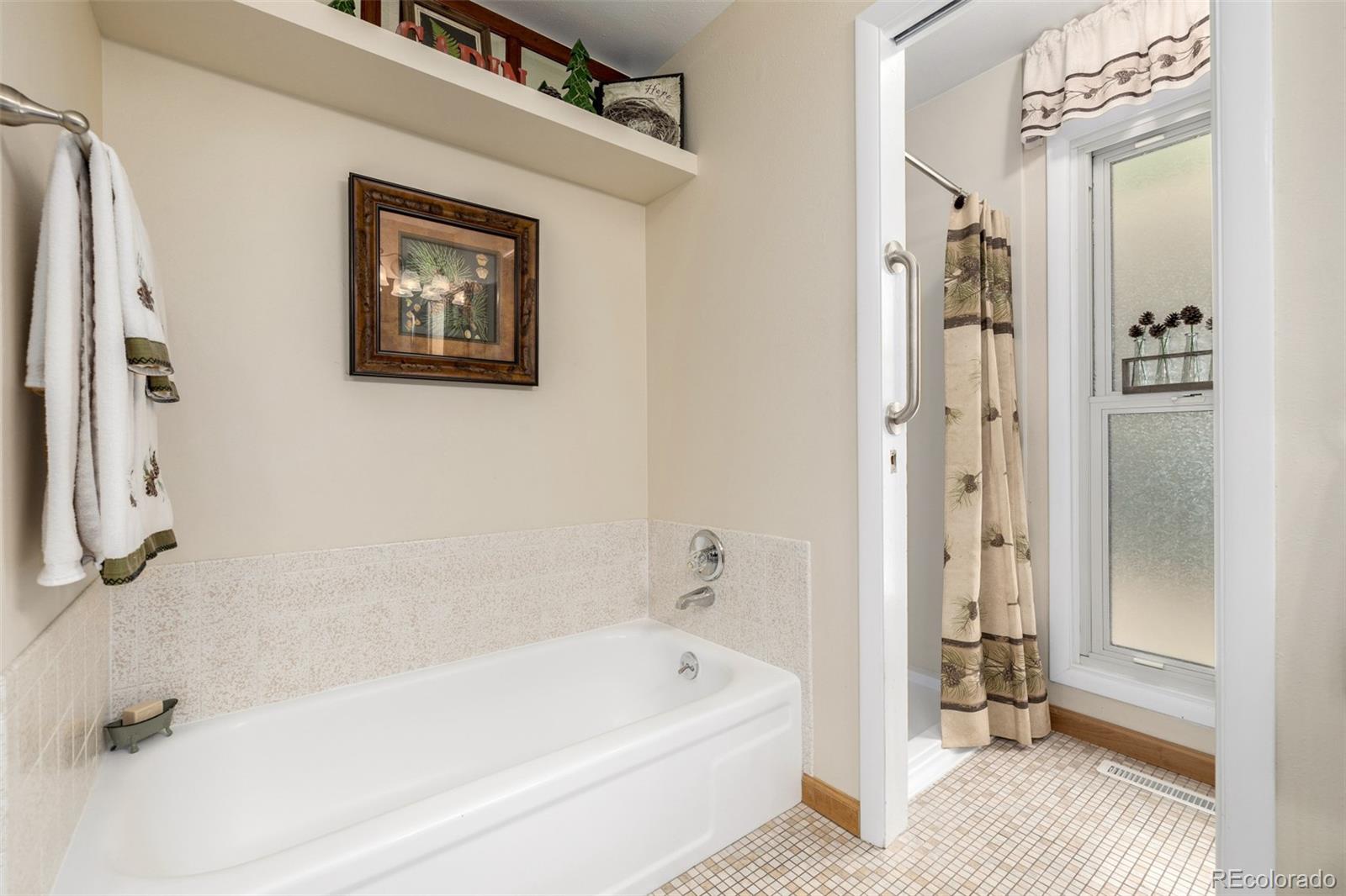 22 Scott Drive North Broomfield, CO 80020 - Photo 31 of 49 a bathroom with a tub a sink and a shower