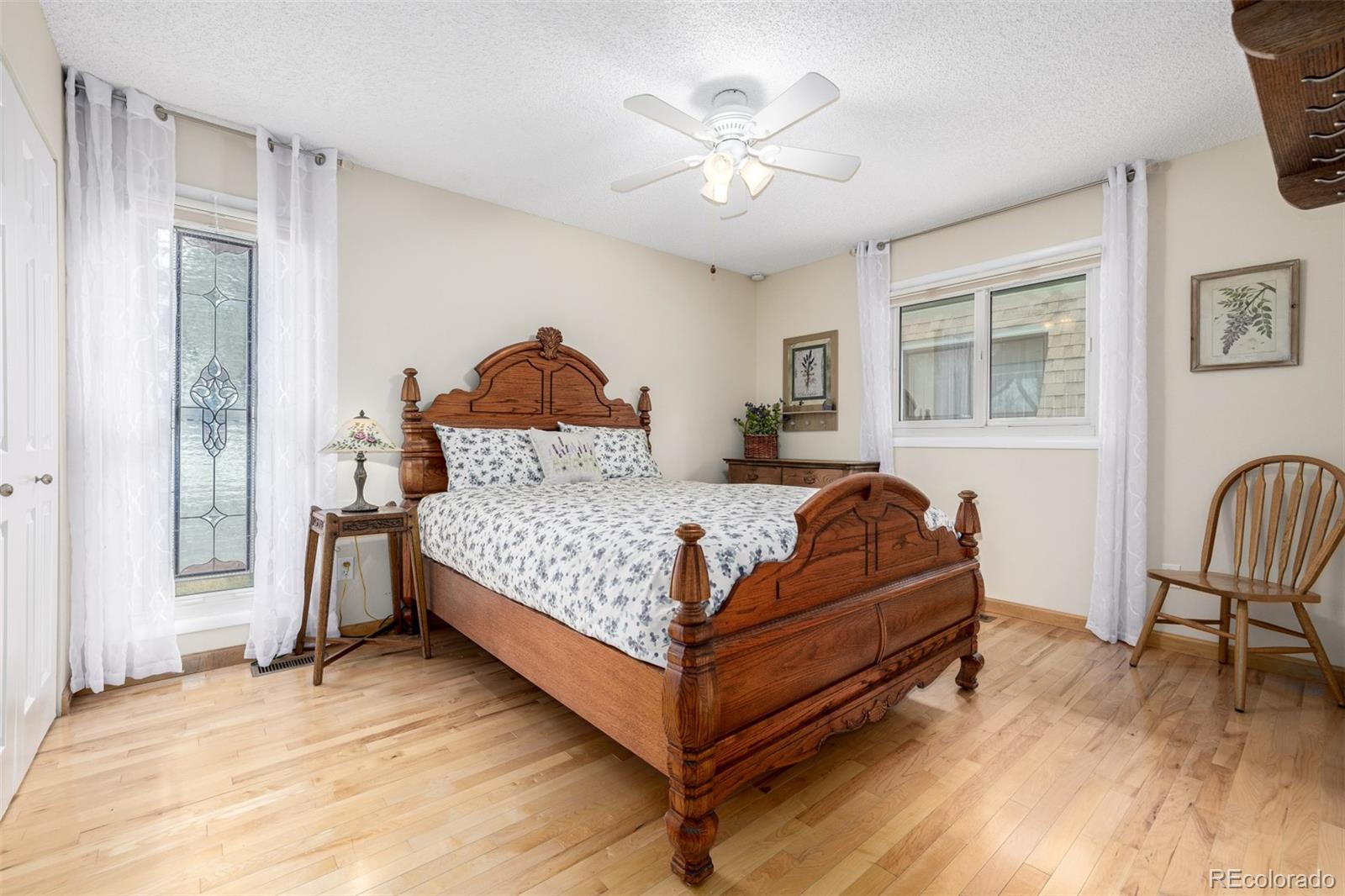 22 Scott Drive North Broomfield, CO 80020 - Photo 32 of 49 a bedroom with a bed and a chandelier