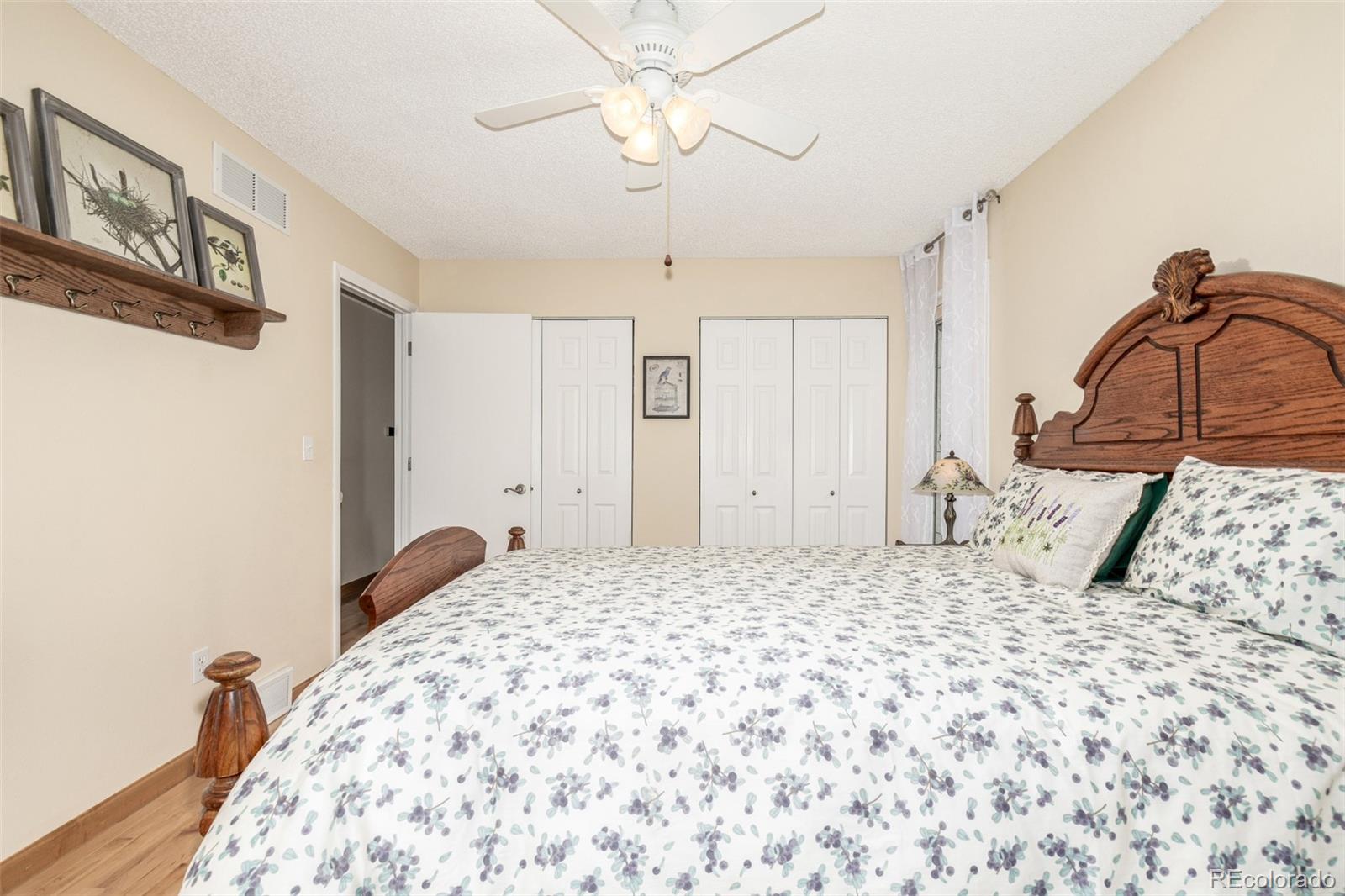 22 Scott Drive North Broomfield, CO 80020 - Photo 33 of 49 a bedroom with a bed and a mirror on the dresser