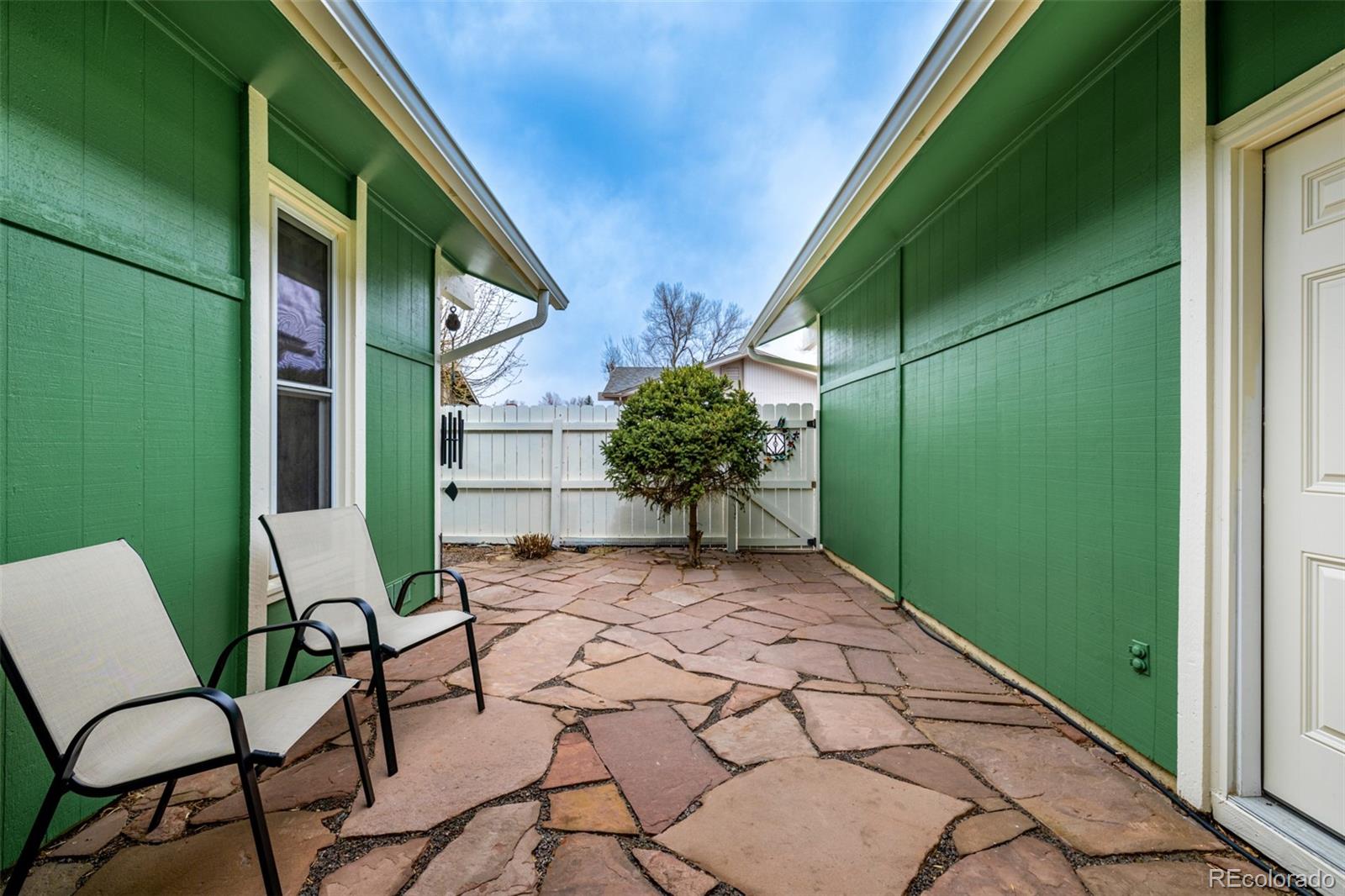 22 Scott Drive North Broomfield, CO 80020 - Photo 39 of 49 a backyard of a house with table and chairs