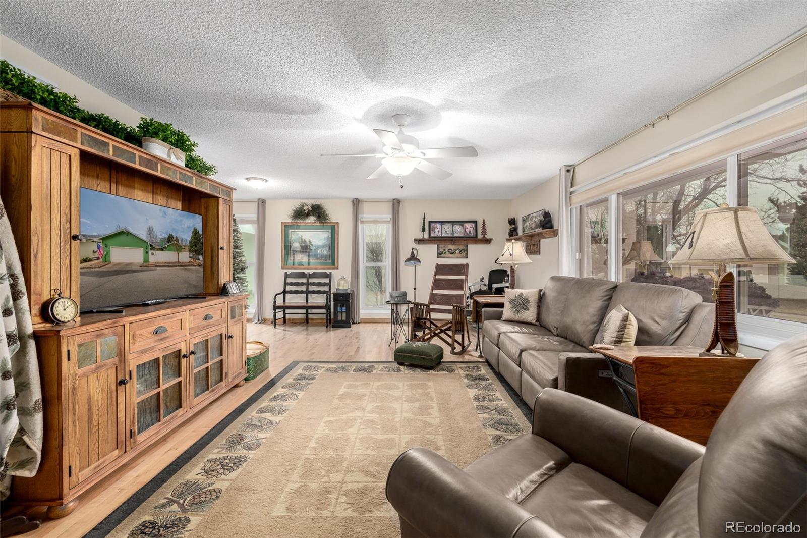 22 Scott Drive North Broomfield, CO 80020 - Photo 9 of 49 a living room with furniture and a flat screen tv