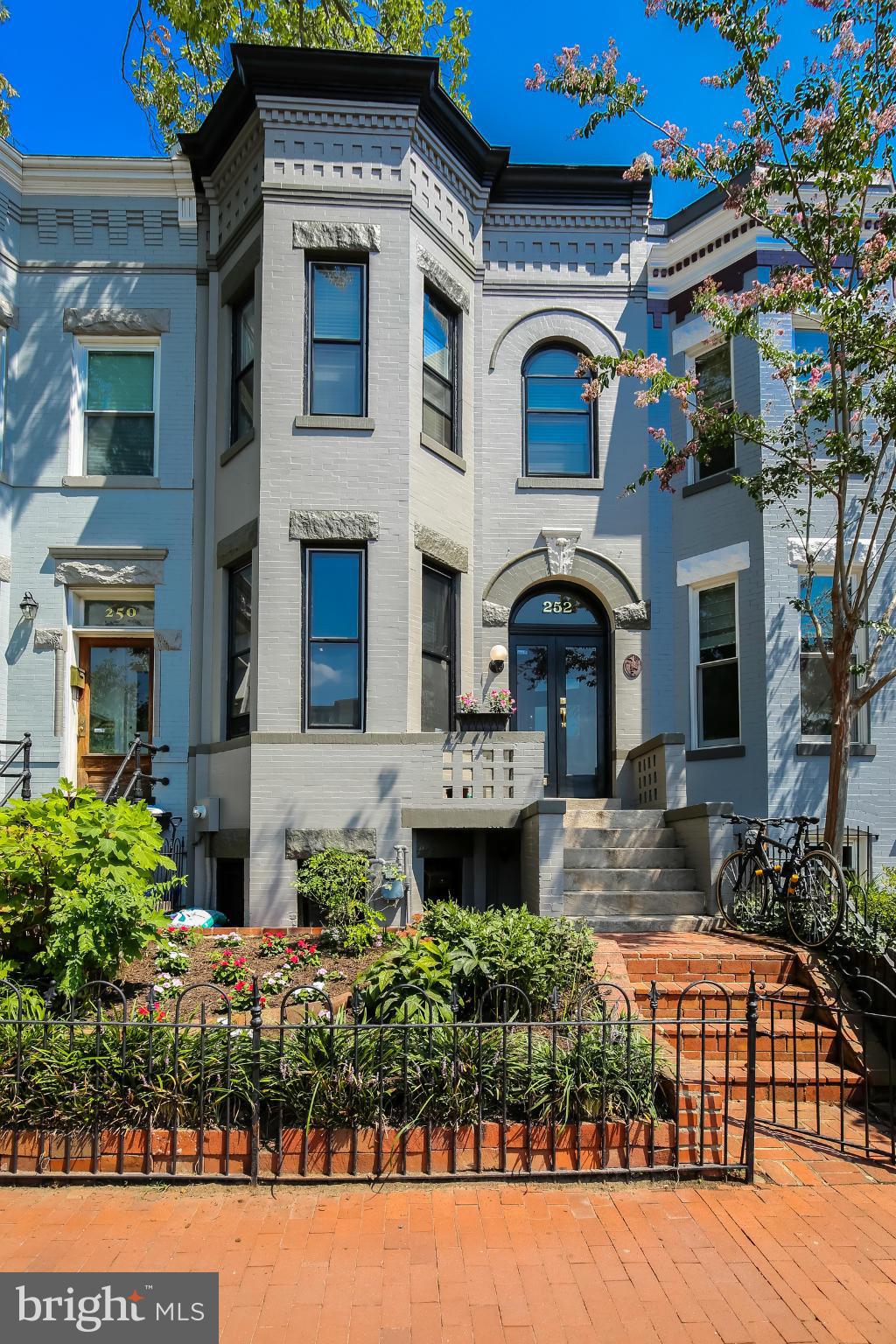 a front view of a house with a garden