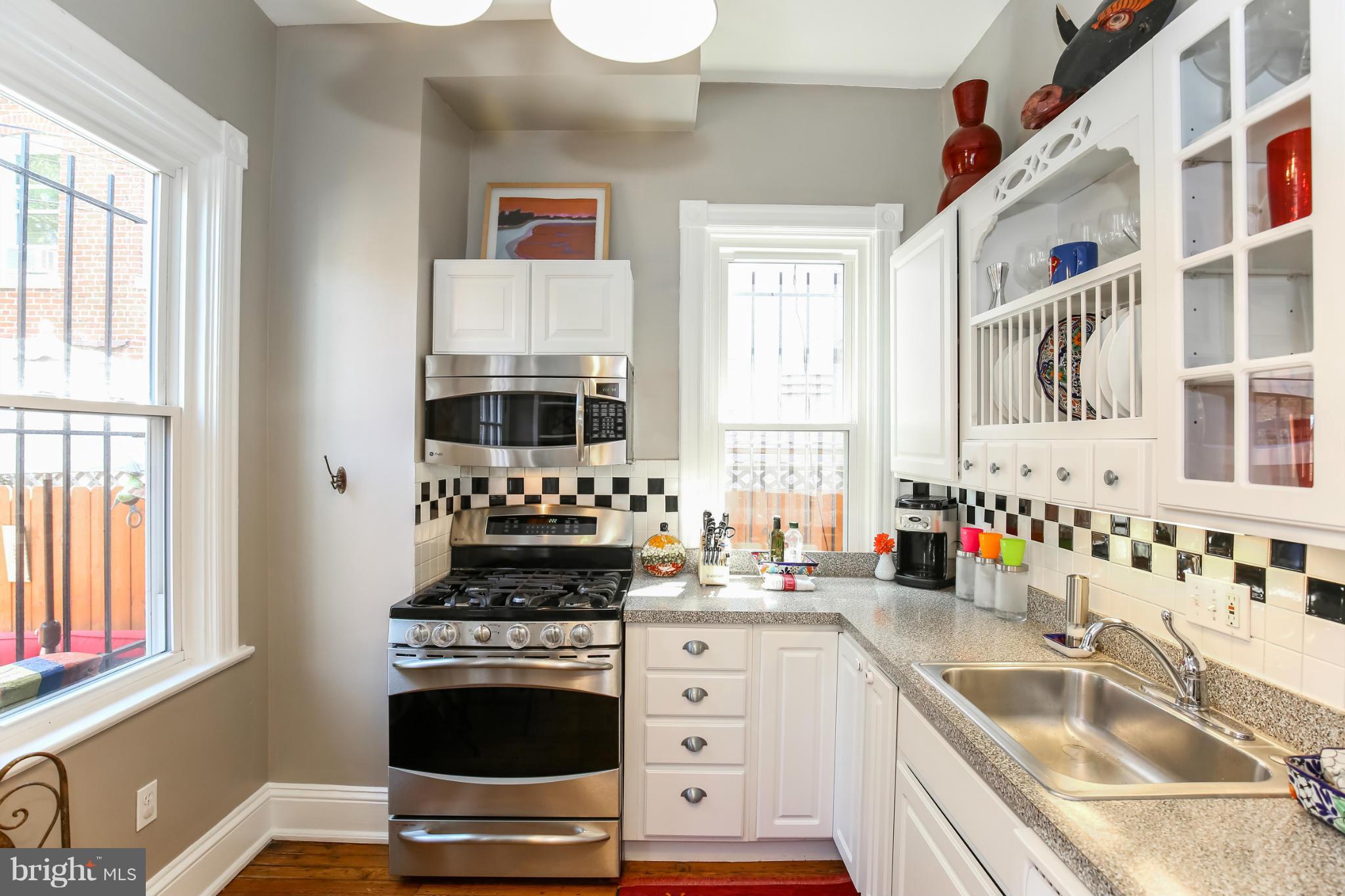 252 8th Street Southeast Washington, DC 20003 - Photo 12 of 29 a kitchen with stainless steel appliances a stove a sink and a microwave