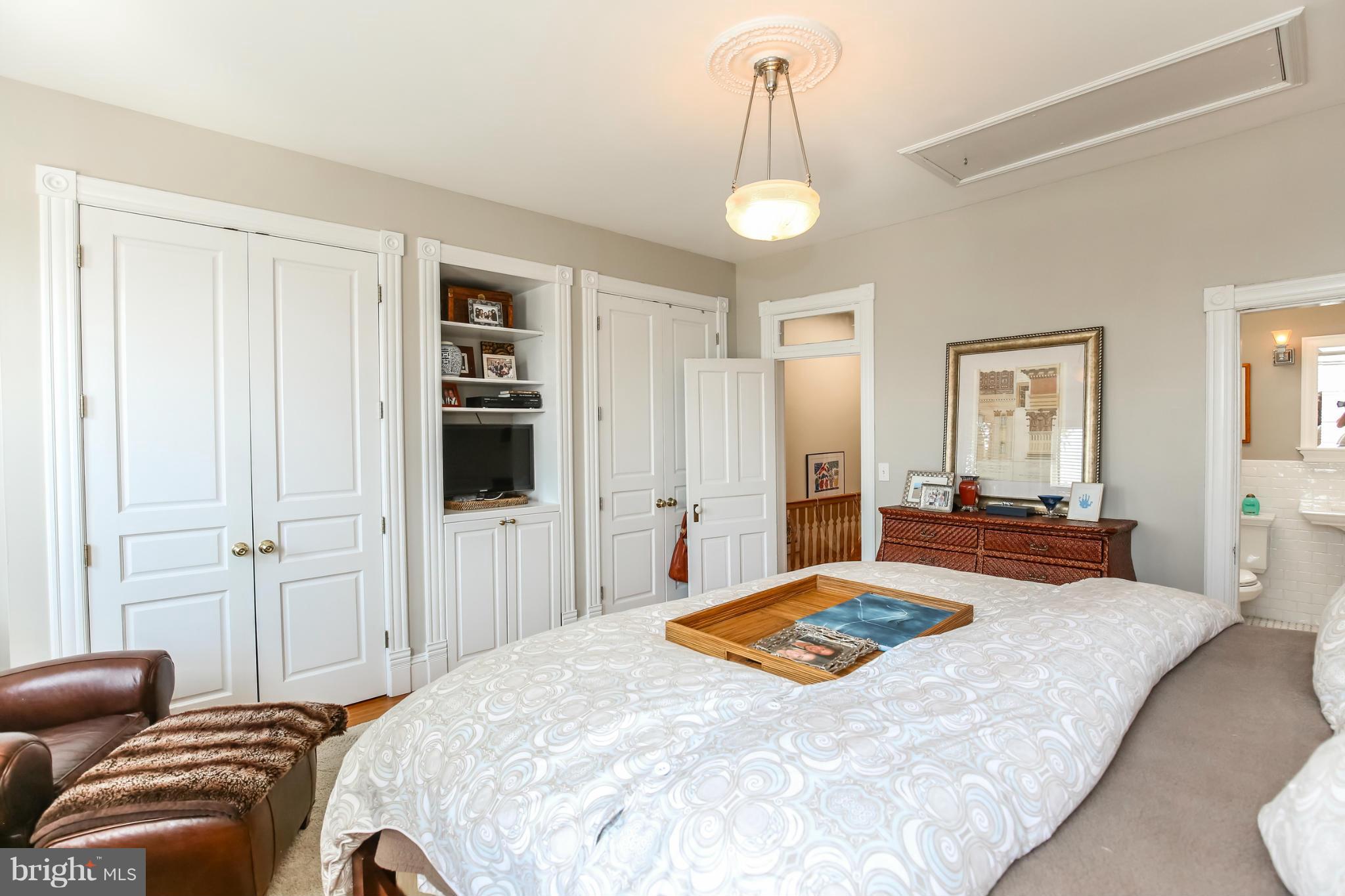 252 8th Street Southeast Washington, DC 20003 - Photo 20 of 29 a bedroom with a bed and wooden floor