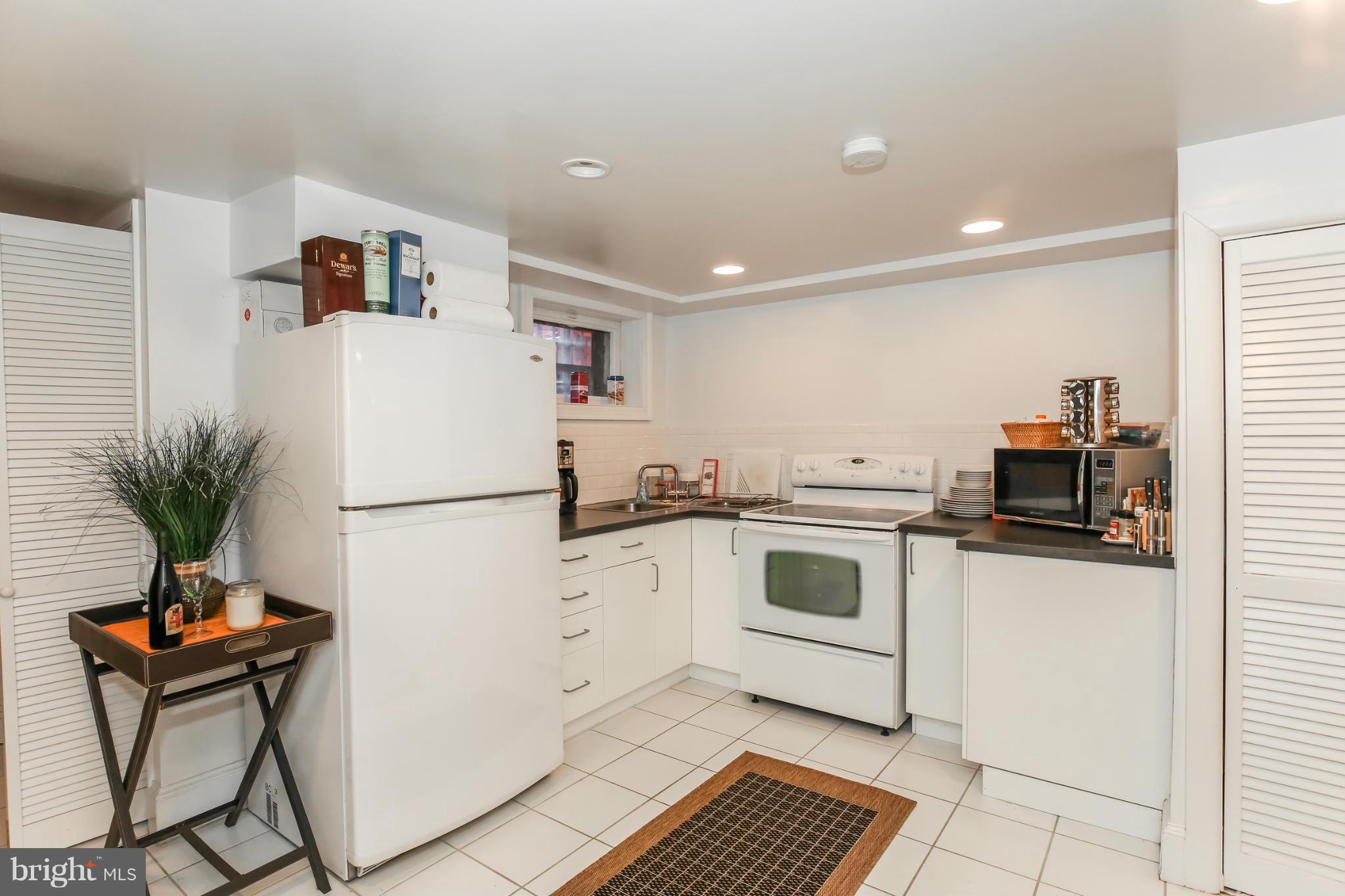 252 8th Street Southeast Washington, DC 20003 - Photo 27 of 29 a white kitchen with cabinets and appliances