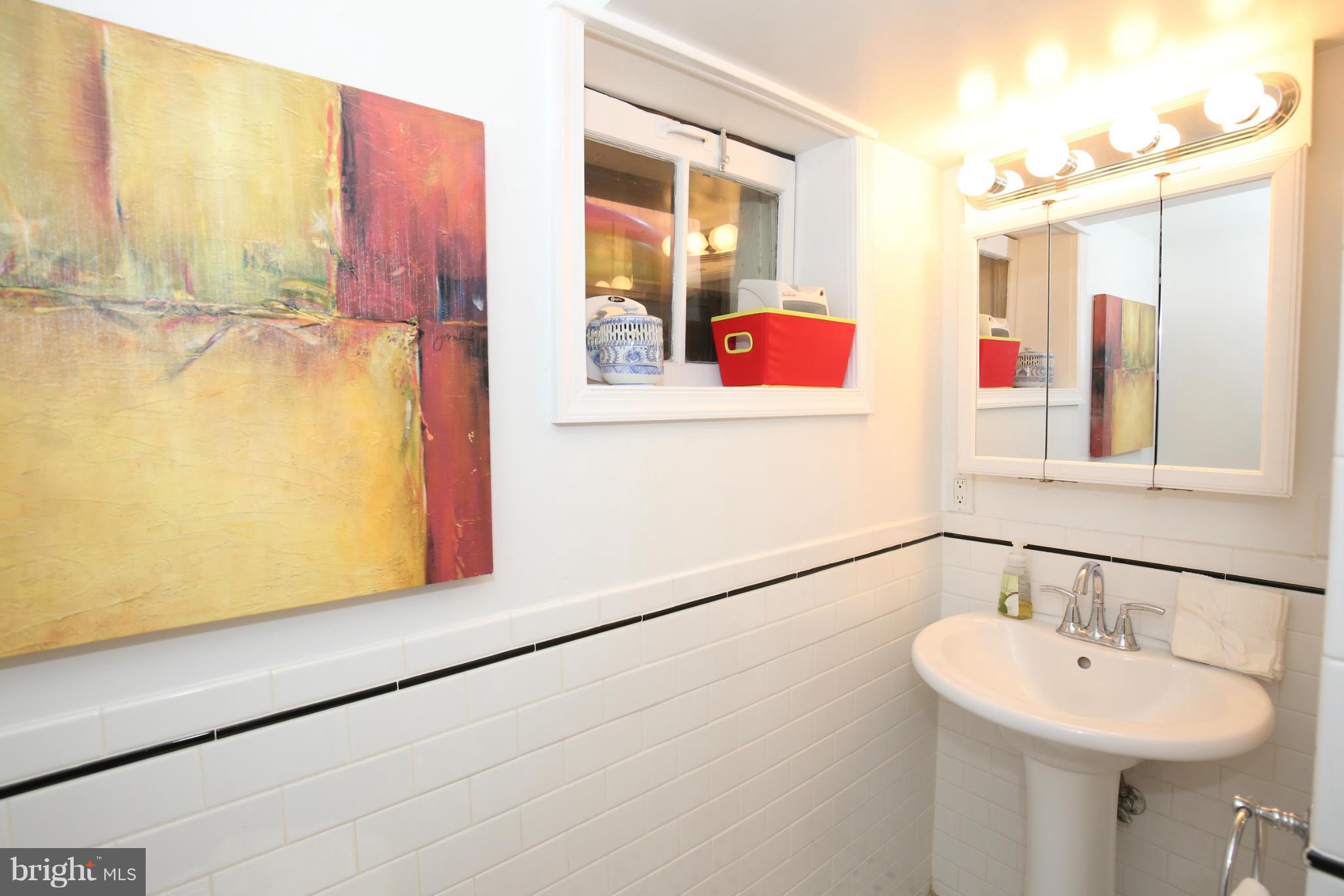 252 8th Street Southeast Washington, DC 20003 - Photo 28 of 29 a bathroom with a sink and a mirror