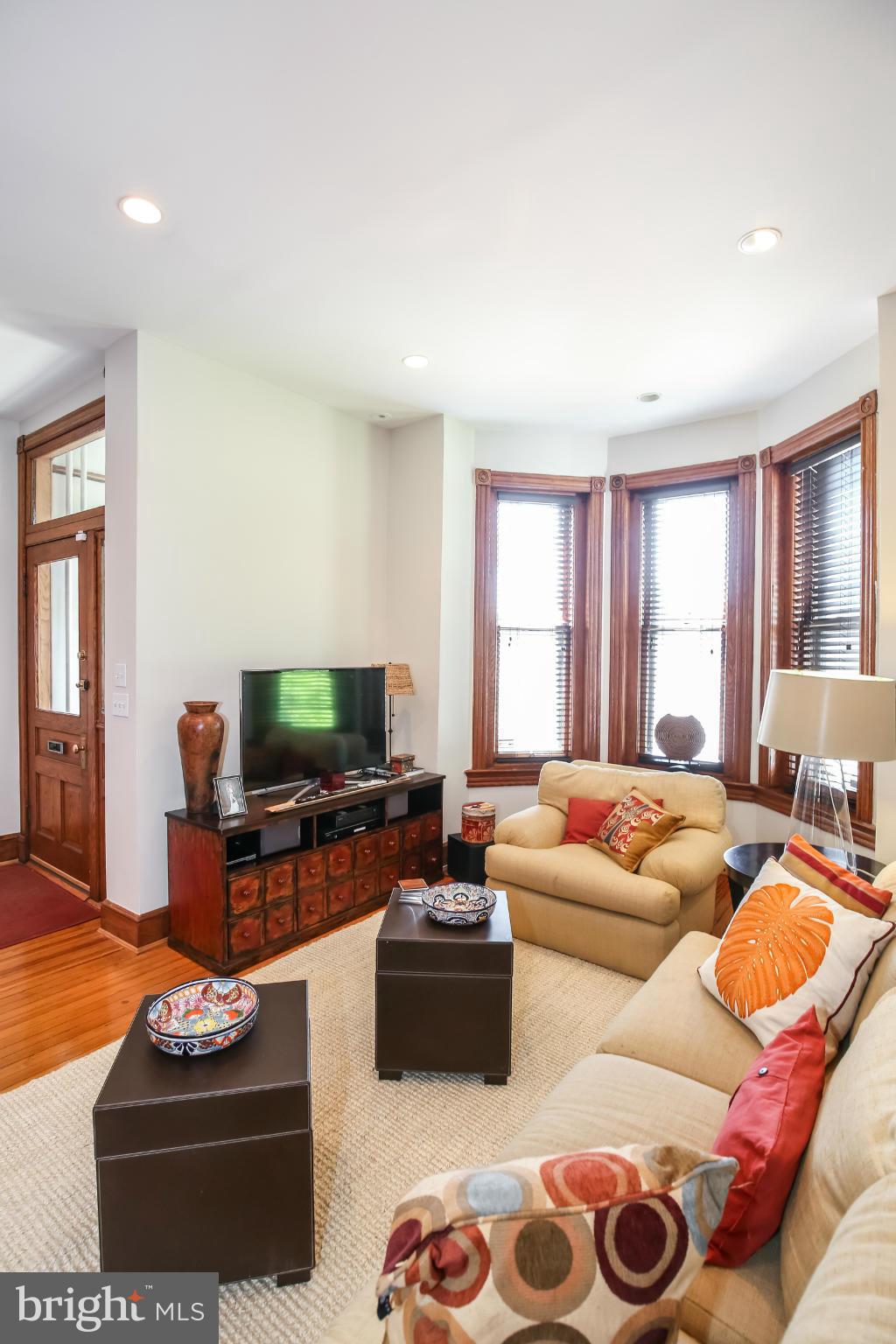 252 8th Street Southeast Washington, DC 20003 - Photo 5 of 29 a living room with furniture a flat screen tv and a window