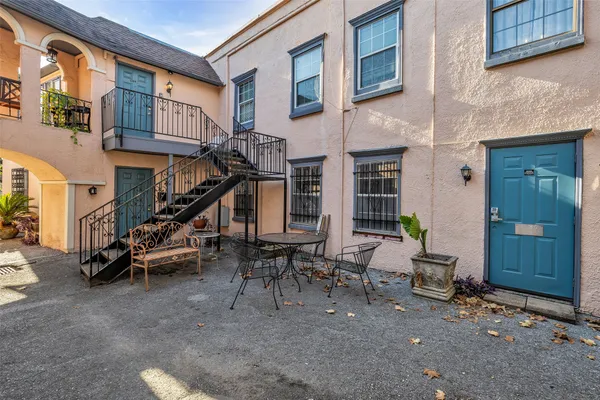 a view of a patio with a table and chairs