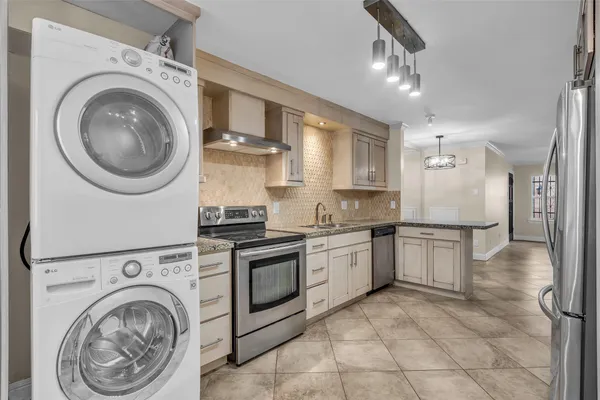 a large kitchen with cabinets and stainless steel appliances