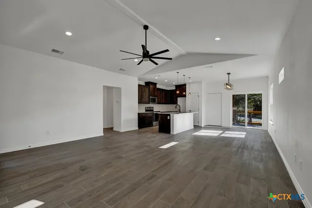 a view of a kitchen with a sink and a stove top oven