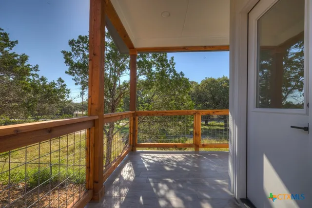 a view of a small deck with flat screen tv