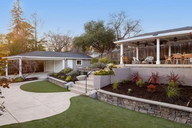 a front view of house with yard seating and green space