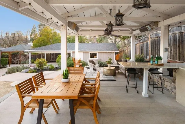 a view of a patio with a table and chairs