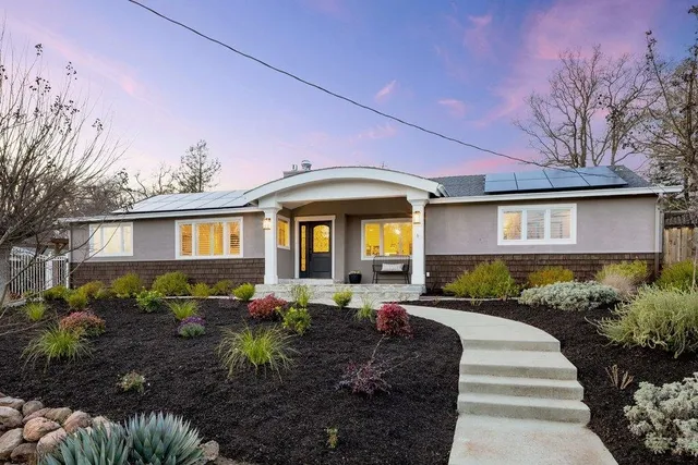 a front view of a house with garden