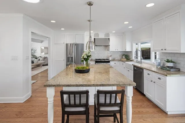 a kitchen with sink a microwave and cabinets