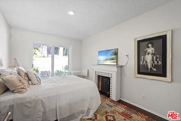 a bedroom with a bed and a fireplace
