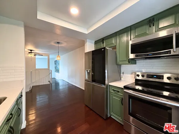 a kitchen with a refrigerator stove and microwave