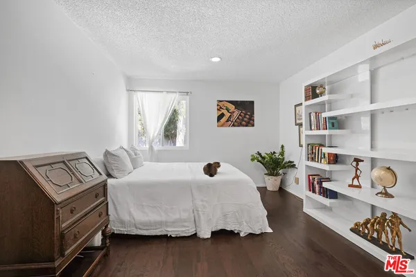 a bedroom with furniture and a window