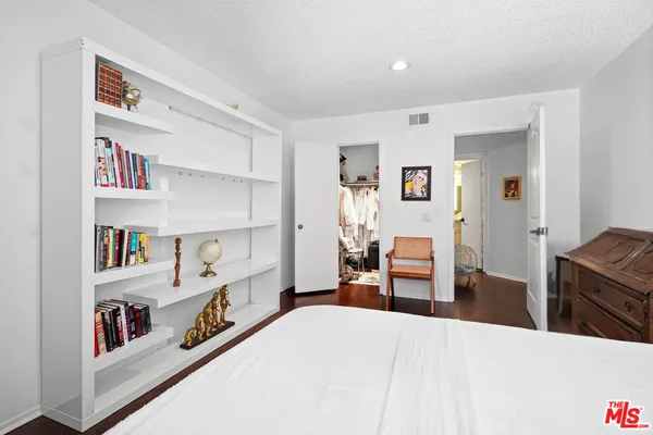a bedroom with furniture and a book shelf