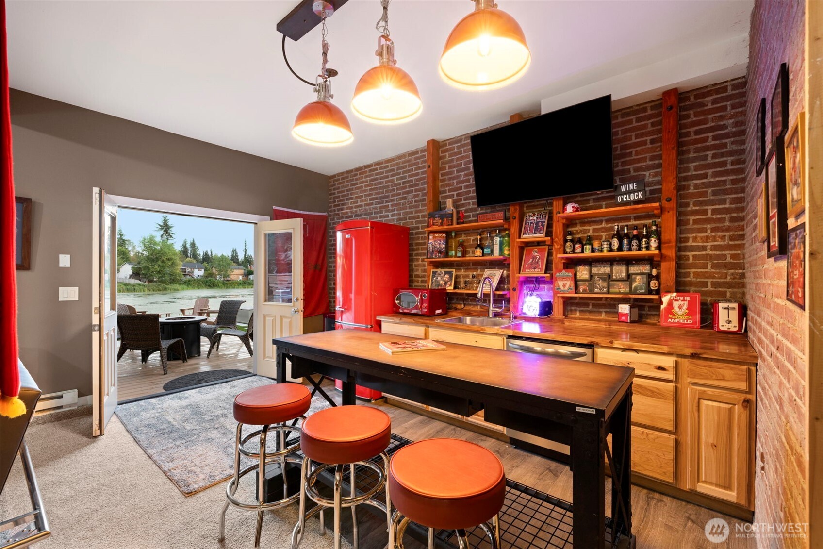 12203 Rainbow Road Arlington, WA 98223 - Photo 23 of 40 a kitchen with a dining table and chairs with wooden floor