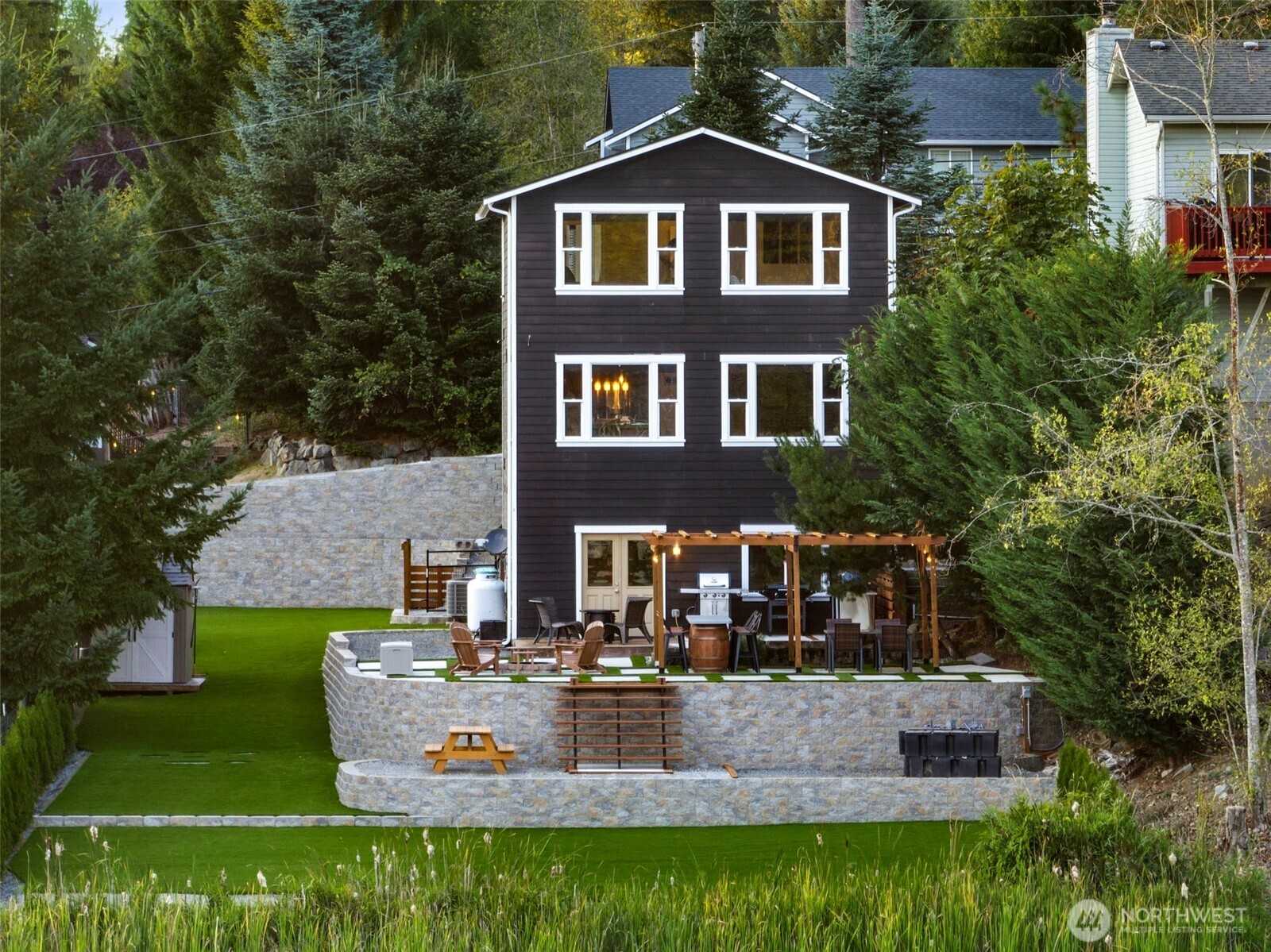 12203 Rainbow Road Arlington, WA 98223 - Photo 33 of 40 a view of a brick house with a yard patio and a fountain