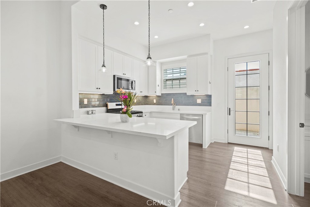 1672 3rd Street Duarte, CA 91010 - Photo 11 of 30 a kitchen with stainless steel appliances a sink a stove a refrigerator and cabinets