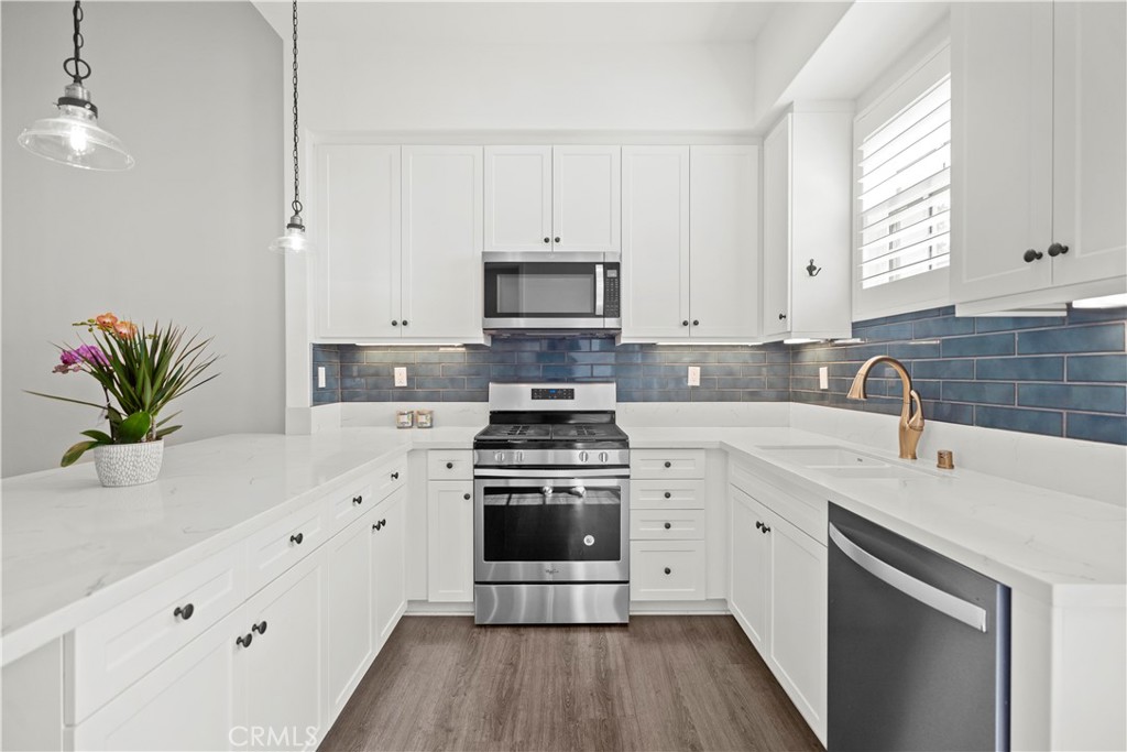 1672 3rd Street Duarte, CA 91010 - Photo 12 of 30 a kitchen with cabinets stainless steel appliances a sink and a potted plant