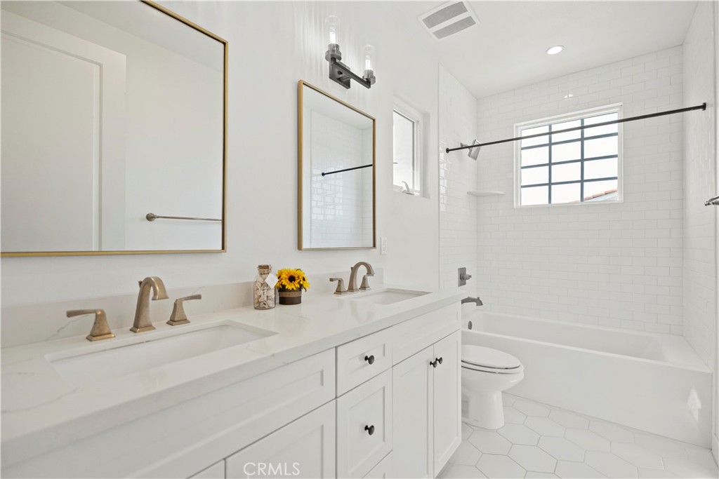 1672 3rd Street Duarte, CA 91010 - Photo 20 of 30 a bathroom with a double vanity sink a toilet and a bathtub
