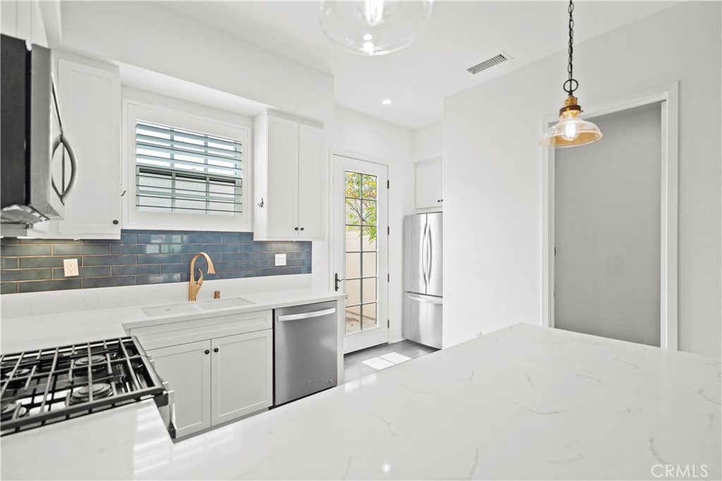 1672 3rd Street Duarte, CA 91010 - Photo 10 of 30 a kitchen with a sink stove and refrigerator