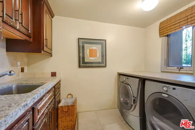 a utility room with a sink a washer and dryer