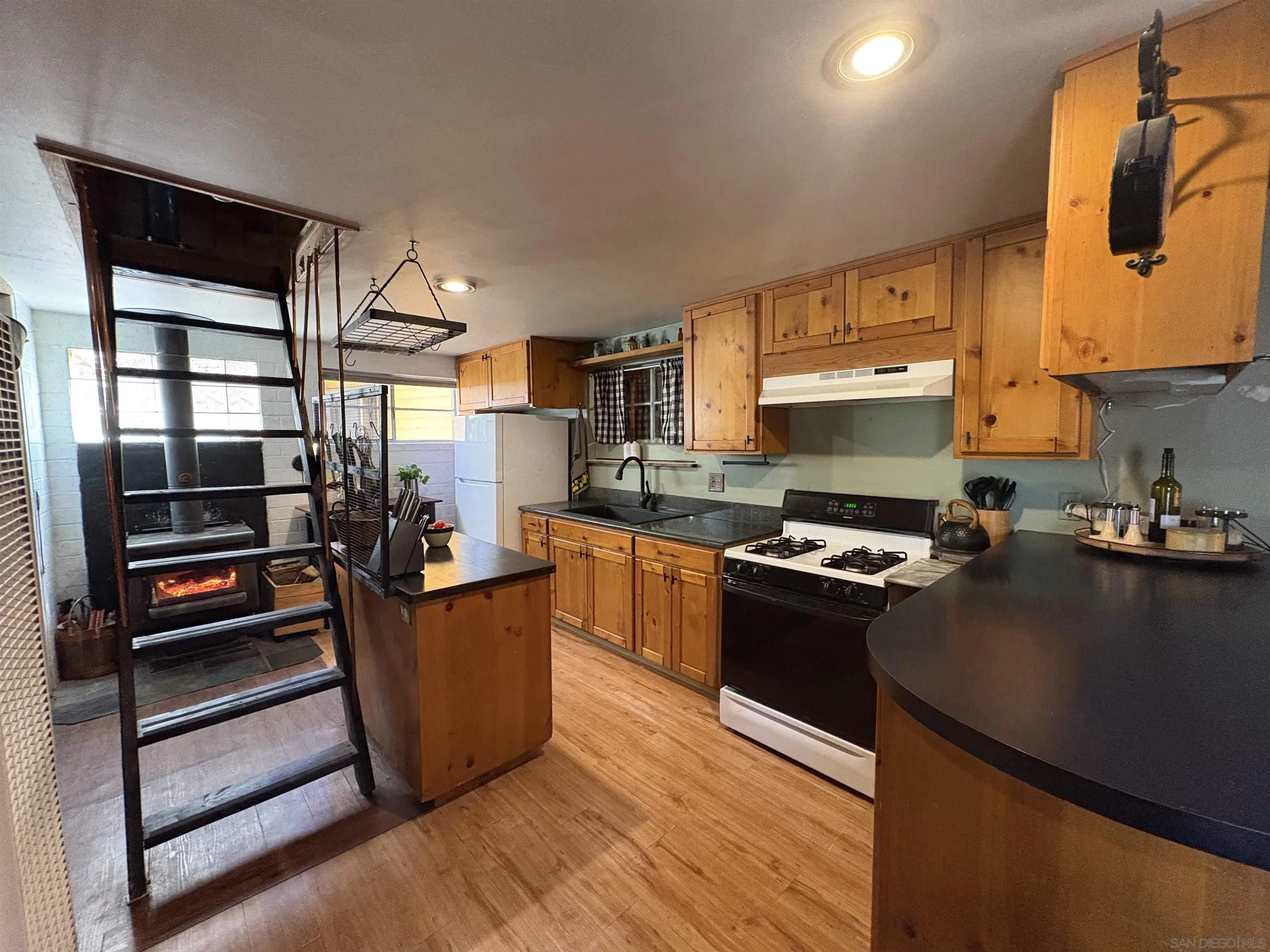 22188 Crestline Road Palomar Mountain, CA 92060 - Photo 24 of 69 a kitchen with stainless steel appliances a stove refrigerator sink and cabinets