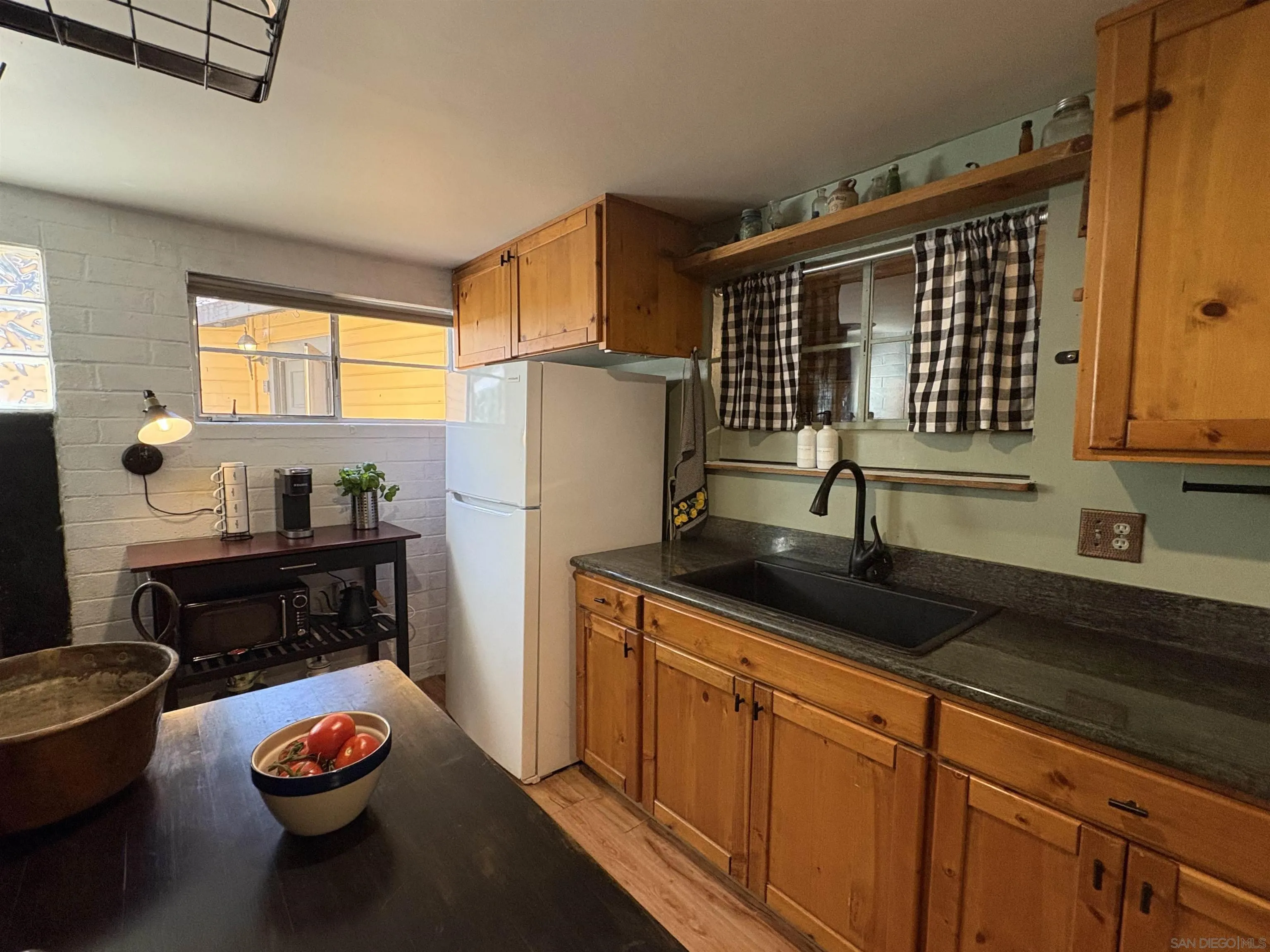 22188 Crestline Road Palomar Mountain, CA 92060 - Photo 27 of 69 a kitchen with granite countertop stainless steel appliances a sink and a refrigerator