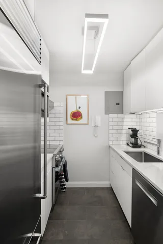 a kitchen with a sink stainless steel appliances and cabinets