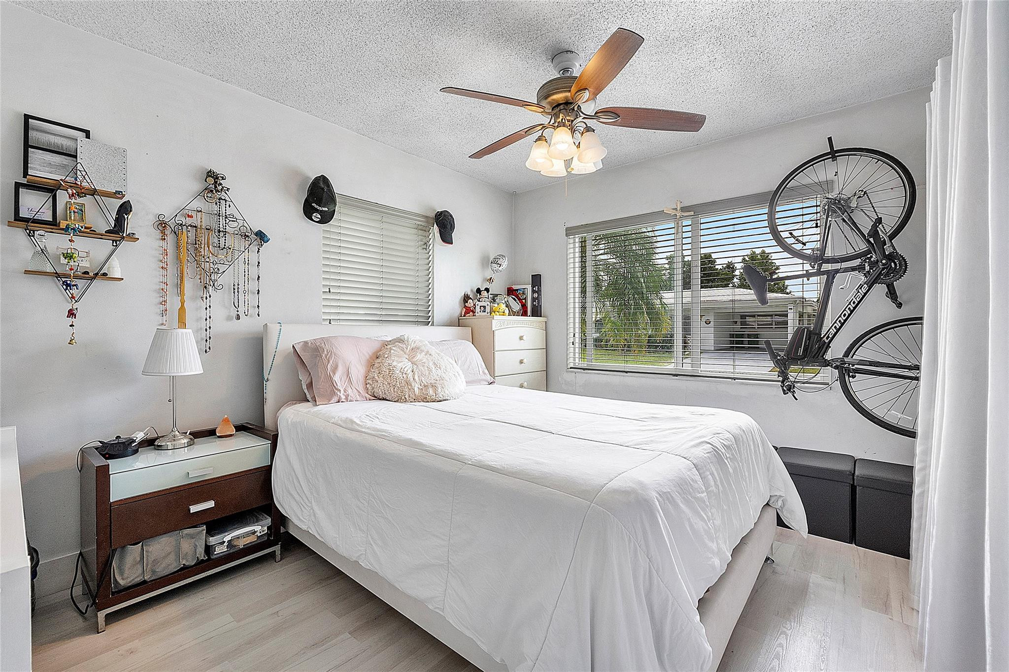 8103 Northwest 58th Place Tamarac, FL 33321 - Photo 14 of 19 a bedroom with a bed and a chandelier