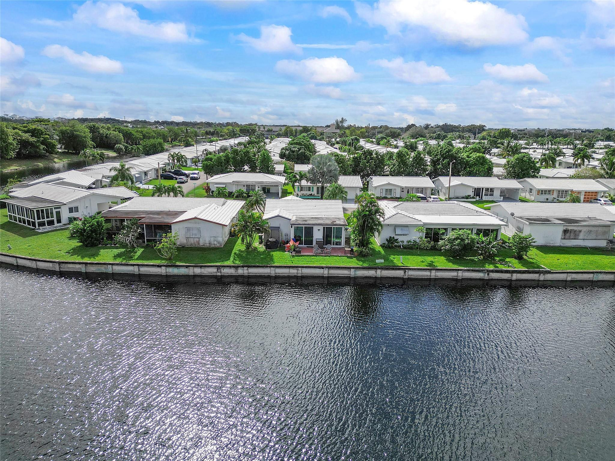 8103 Northwest 58th Place Tamarac, FL 33321 - Photo 18 of 19 an aerial view of a house with a garden and lake view