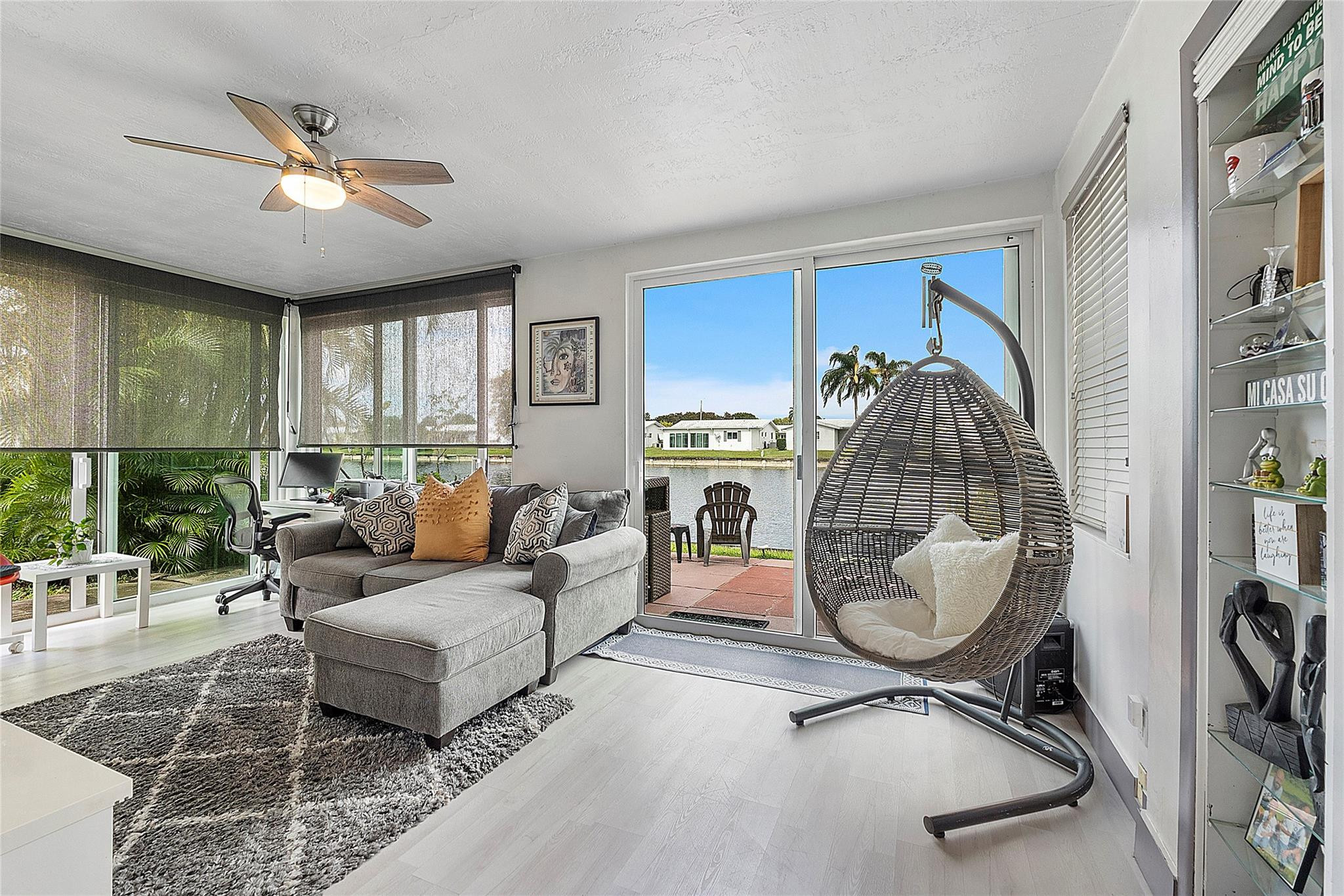 8103 Northwest 58th Place Tamarac, FL 33321 - Photo 3 of 19 a living room with furniture a chandelier and a floor to ceiling window