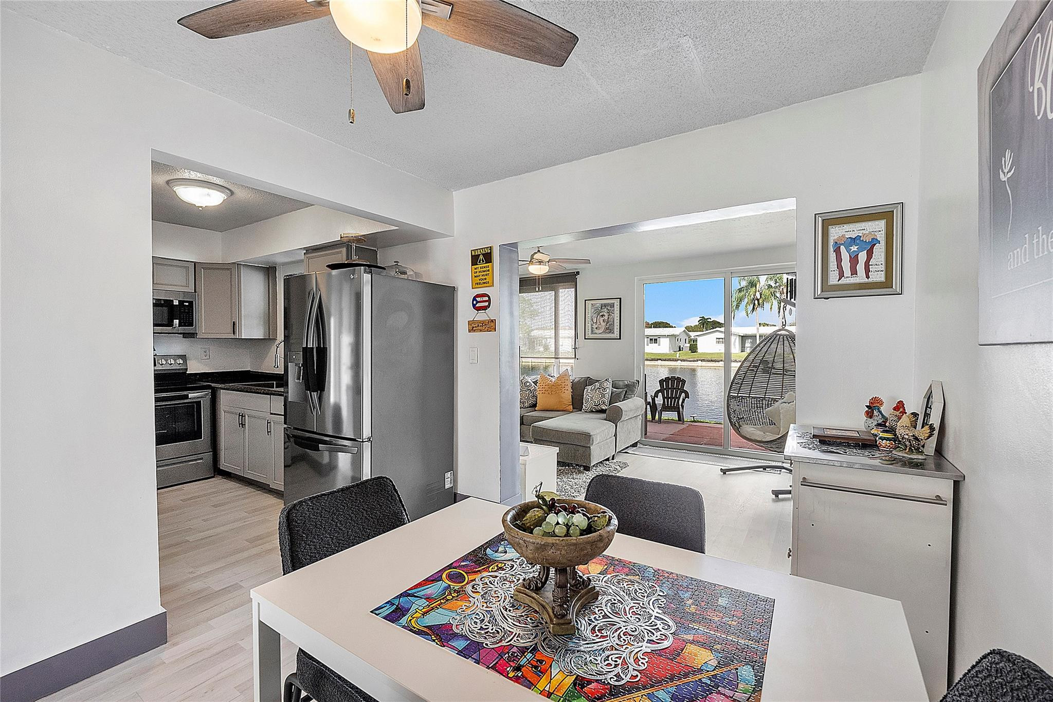 8103 Northwest 58th Place Tamarac, FL 33321 - Photo 7 of 19 a living room with furniture and kitchen view