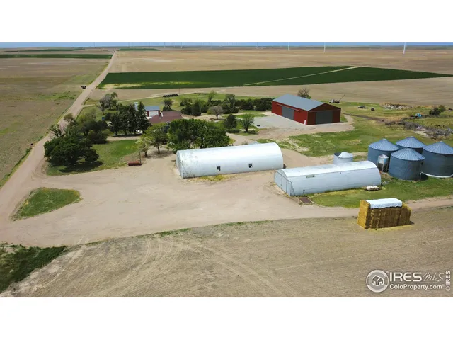 a balcony with two chairs and a table