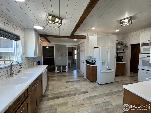 a kitchen with stainless steel appliances a refrigerator and a stove top oven