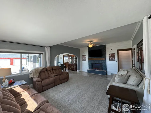 a living room with furniture ceiling fan and a rug
