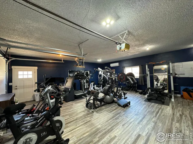 a bathroom with a granite countertop sink a toilet a mirror and shower
